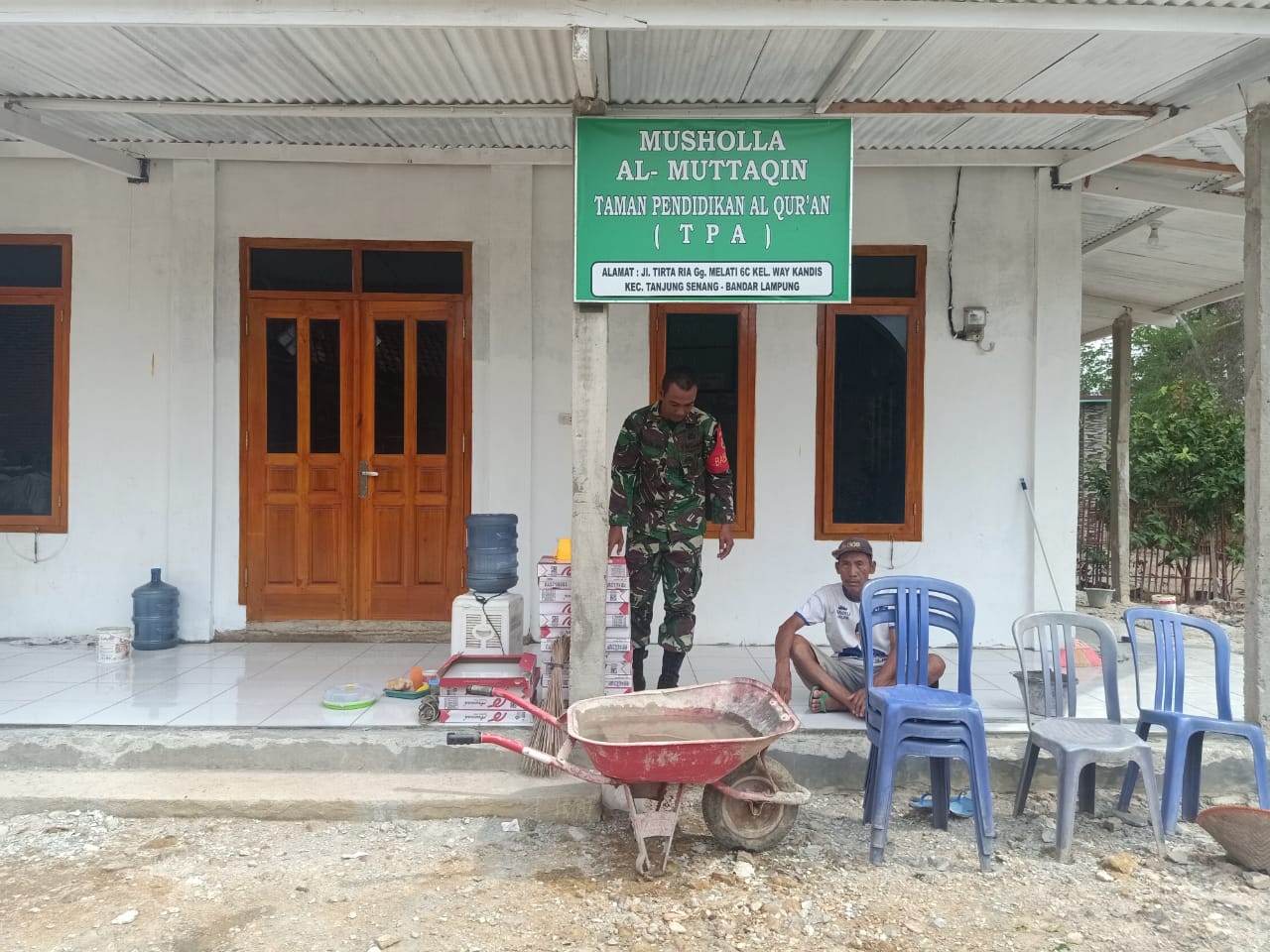 Babinsa Waykandis Bantu Pemasangan Keramik Musholla Al-Mutaqqin